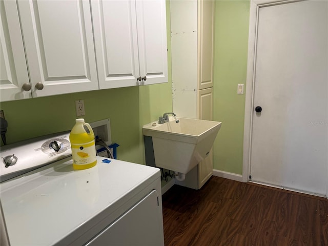 laundry room featuring sink, cabinets, dark wood-type flooring, and washer / clothes dryer