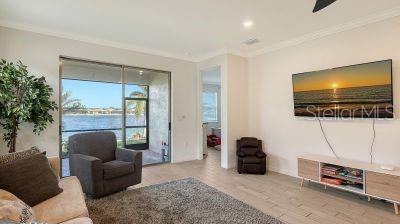 living room featuring hardwood / wood-style flooring and ornamental molding