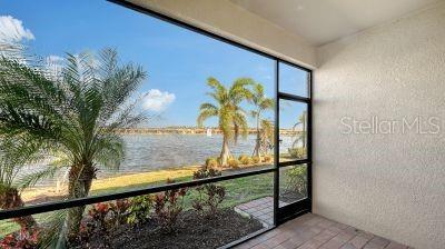 unfurnished sunroom featuring a water view