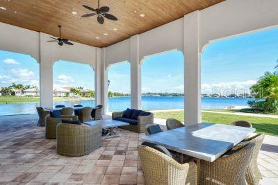 view of patio with ceiling fan, a water view, and an outdoor hangout area