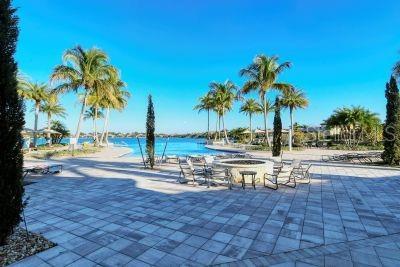 view of swimming pool with a water view and a patio