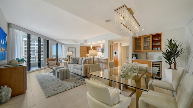 tiled dining area with a wall of windows, sink, and wine cooler