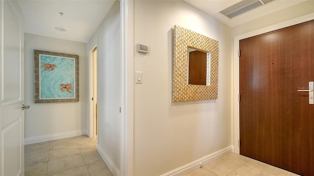 corridor featuring light tile patterned floors