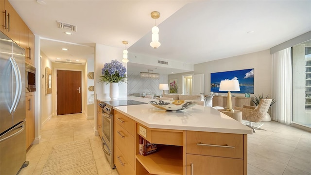 kitchen featuring backsplash, stainless steel appliances, decorative light fixtures, a kitchen island, and light tile patterned flooring