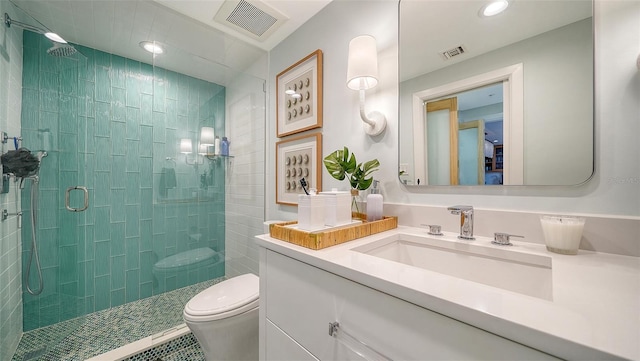 bathroom featuring walk in shower, vanity, and toilet