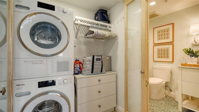 clothes washing area with stacked washer / drying machine