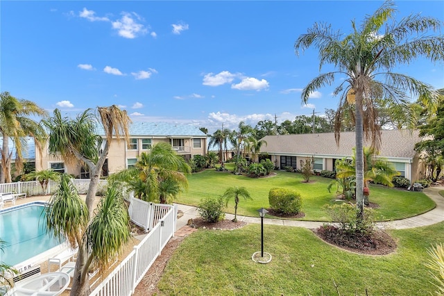 view of home's community with a lawn and a swimming pool