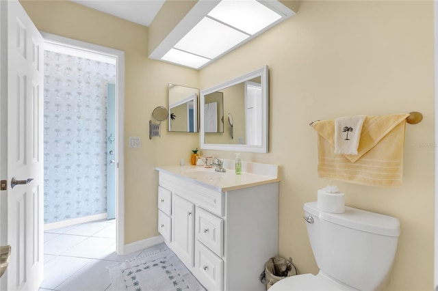 bathroom featuring tile patterned flooring, vanity, and toilet