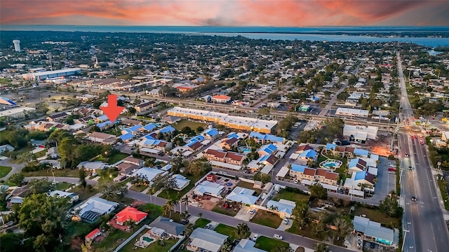 aerial view at dusk with a water view