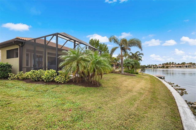 view of yard with a water view and a lanai