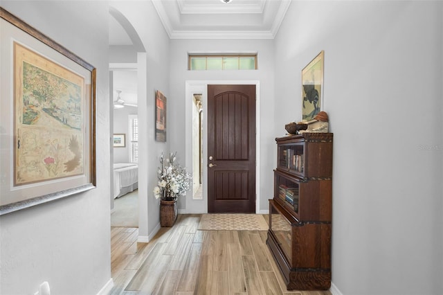 entrance foyer featuring a wealth of natural light, ceiling fan, and crown molding