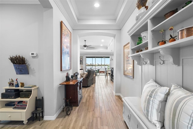 mudroom with light hardwood / wood-style floors, ceiling fan, ornamental molding, and a tray ceiling