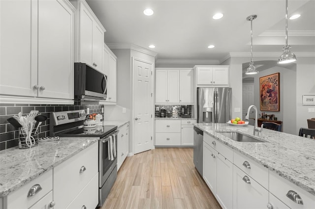 kitchen with white cabinetry, sink, and stainless steel appliances