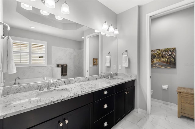 bathroom featuring a tub to relax in, vanity, and toilet