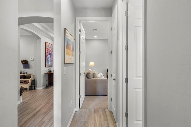 corridor with light wood-type flooring