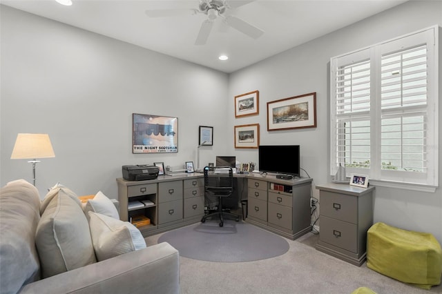 carpeted home office with ceiling fan