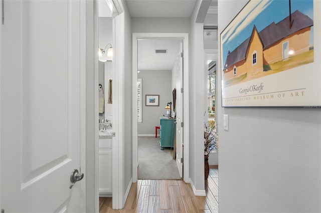 corridor with light hardwood / wood-style floors