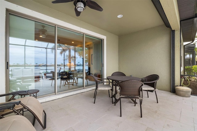 view of patio / terrace with ceiling fan and a water view