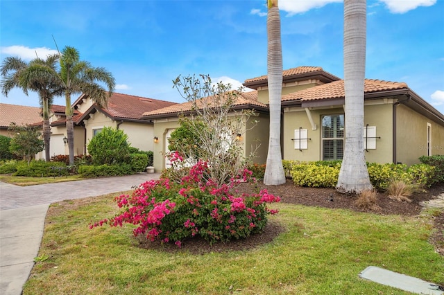 mediterranean / spanish home featuring a front yard