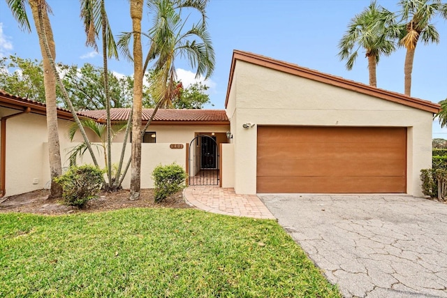 view of front of property with a front yard and a garage