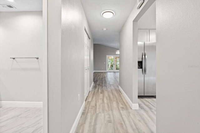 hallway with light hardwood / wood-style flooring