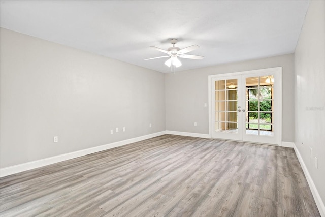 empty room with ceiling fan, french doors, and light hardwood / wood-style floors