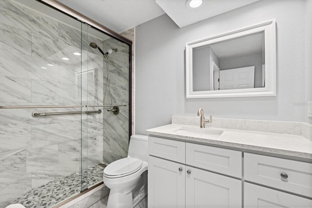 bathroom with toilet, an enclosed shower, and vanity