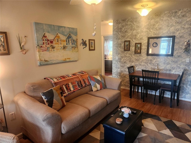 living room with hardwood / wood-style flooring and ceiling fan