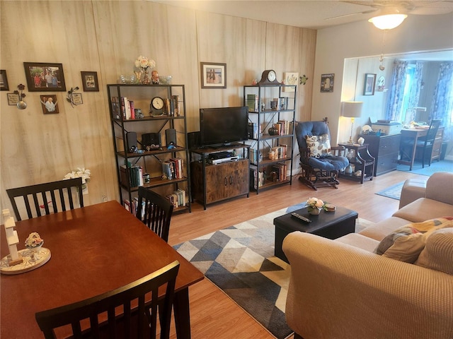 living room with hardwood / wood-style floors and ceiling fan