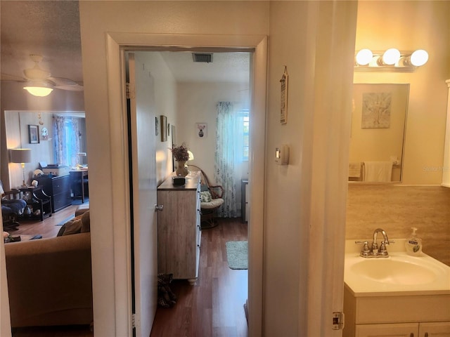 bathroom with hardwood / wood-style floors, vanity, and toilet