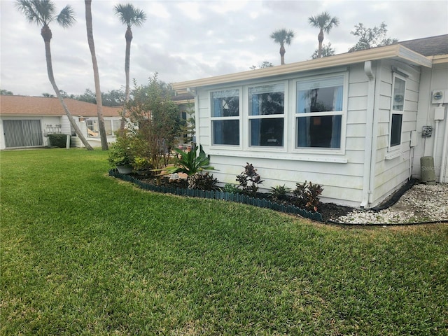 view of side of home with a lawn