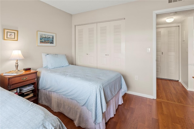 bedroom with a closet and hardwood / wood-style floors