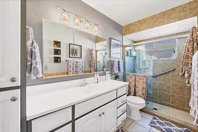 bathroom featuring tile patterned flooring, an enclosed shower, vanity, and toilet