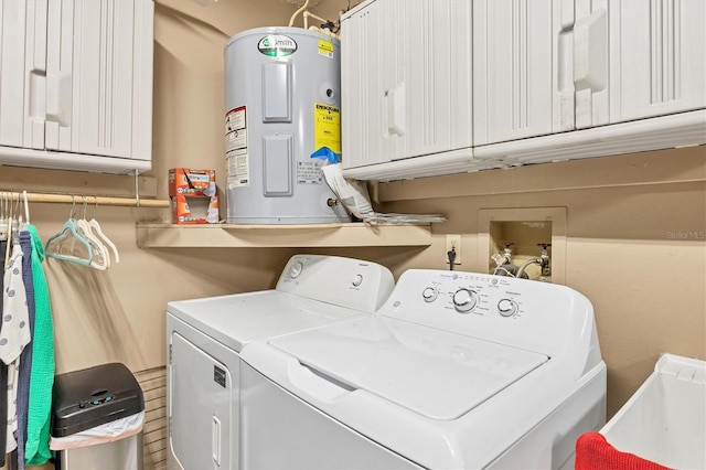 washroom featuring washer and dryer, cabinets, and water heater