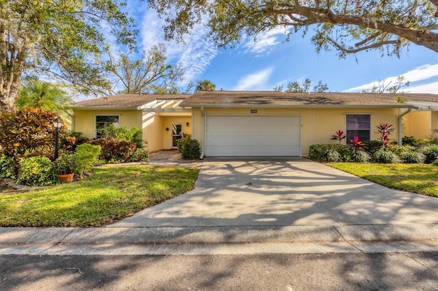 single story home featuring a front yard and a garage