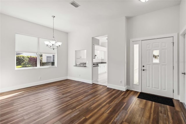 entrance foyer with wood-type flooring and a notable chandelier