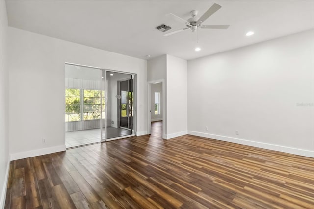 unfurnished room featuring ceiling fan and dark wood-type flooring