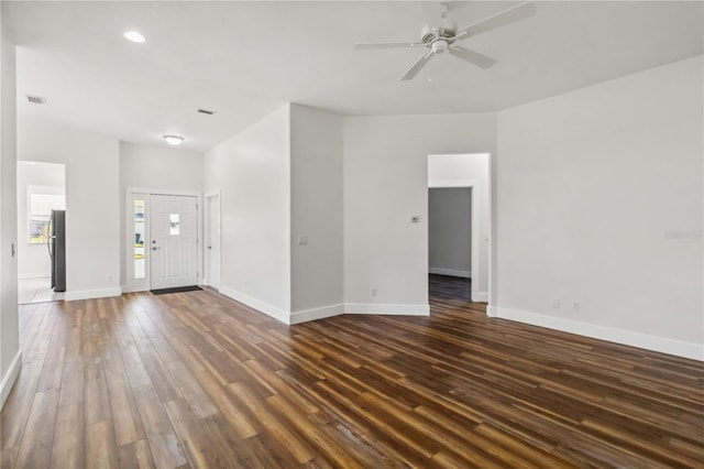 empty room featuring ceiling fan and dark hardwood / wood-style flooring