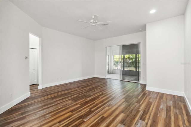 empty room with dark hardwood / wood-style floors and ceiling fan