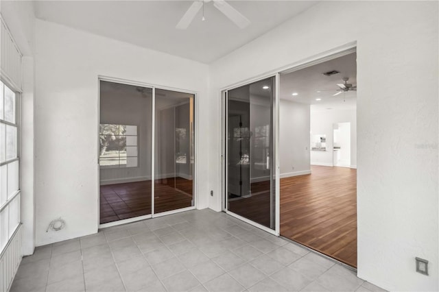 unfurnished sunroom featuring ceiling fan