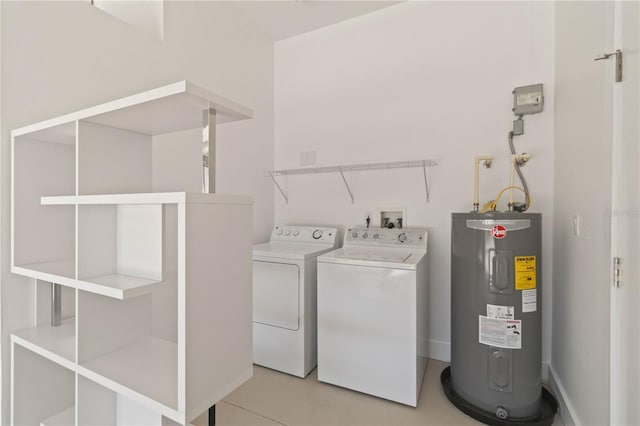 washroom featuring washer and clothes dryer, electric water heater, and light tile patterned floors