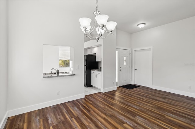 interior space featuring hardwood / wood-style flooring, a notable chandelier, and sink