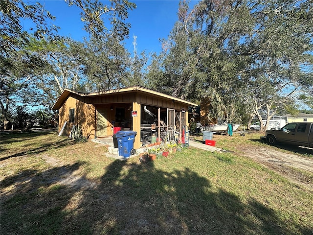 view of side of property with a yard