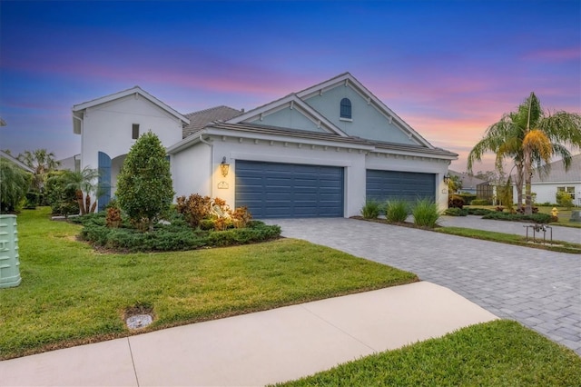 view of front of property featuring a garage and a yard