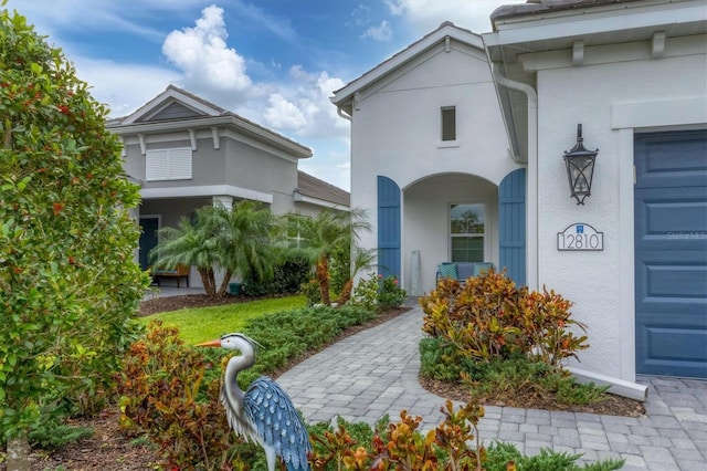 entrance to property featuring stucco siding