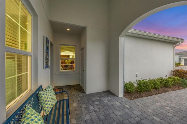 doorway to property with a patio area and stucco siding