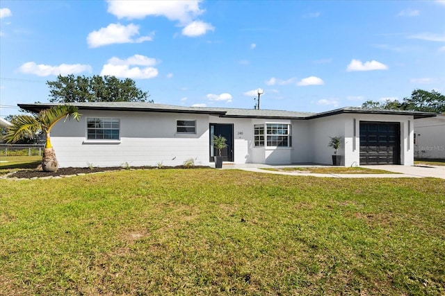 ranch-style house with a garage and a front lawn