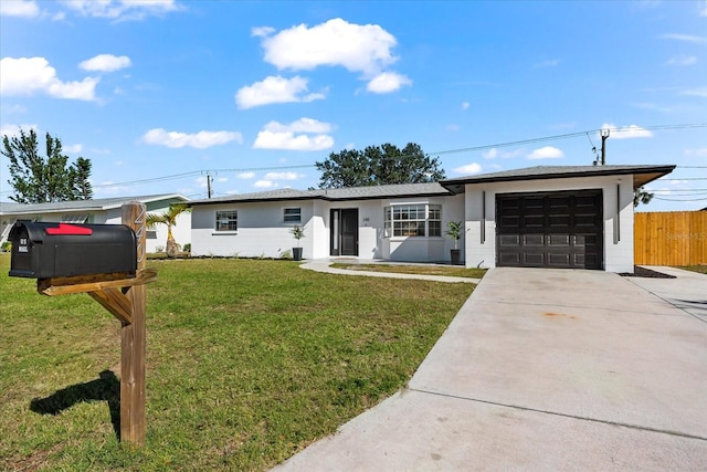 ranch-style house featuring a front yard and a garage