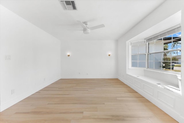 empty room featuring ceiling fan and light hardwood / wood-style flooring