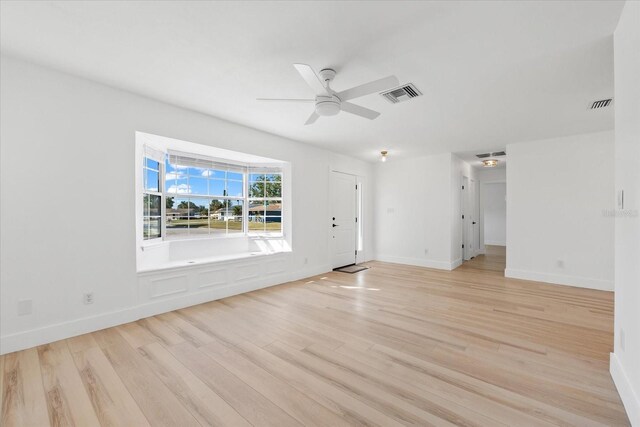 unfurnished living room with ceiling fan and light wood-type flooring